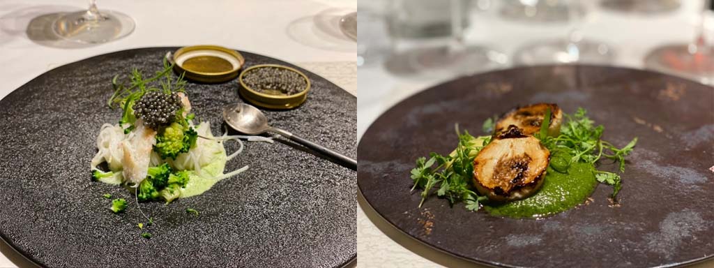レストランの芸術的な創作料理が黒いお皿に盛り付けられています